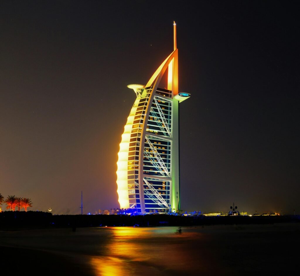 Iconic Burj Al Arab Jumeirah Hotel illuminated at night in Dubai.